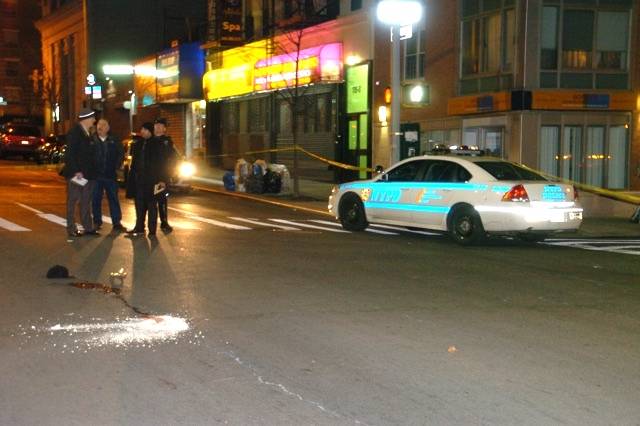 Investigators at the scene of a fatal hit-and-run in East Harlem last year.